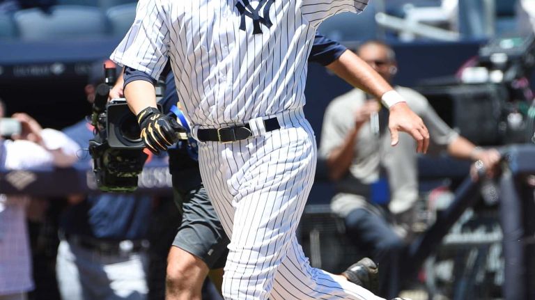 Former New York Yankees player Hideki Matsui waves to fans after his two-run home run during the 70th annual Old-Timers' game at Yankee Stadium on Sunday, June 12, 2016.
