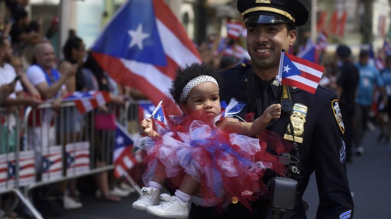 Puerto Rican Day Parade 2016 held in NYC: See photos from the Fifth Avenue festivities 57 NYPD Sgt. Angel Ramos carries his daughter Angolina as he marches in the 59th annual Puerto Rican Day Parade in Manhattan on Sunday, June 12, 2016.