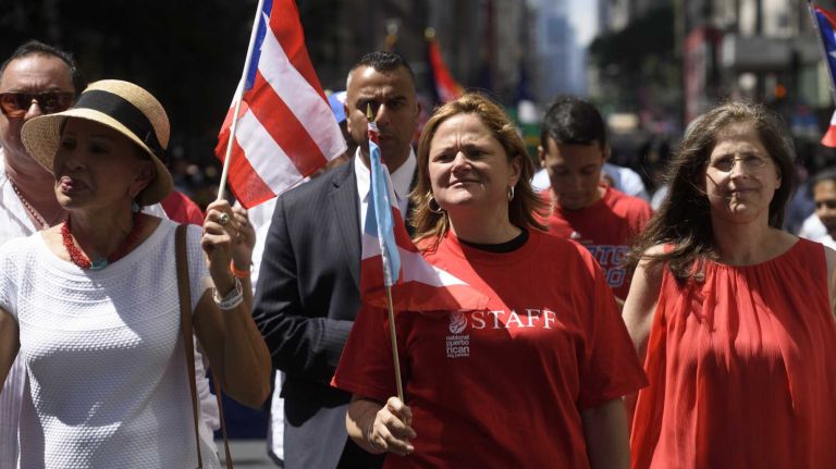 New York City Council Speaker Melissa Mark-Viverito, center, marches along Fifth Avenue during the 59th annual Puerto Rican Day Parade in Manhattan on Sunday, June 12, 2016.