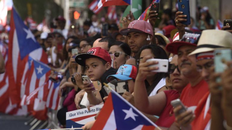 Spectators line Fifth Avenue to celebrate during the 59th annual Puerto Rican Day Parade in Manhattan on Sunday, June 12, 2016. 