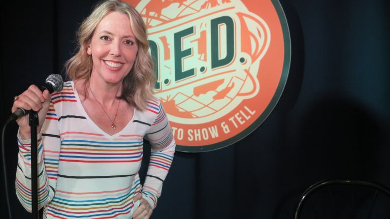 Kambri Crews, the owner of Q.E.D. Astoria, is celebrating five years in the Queens neighborhood. She is pictured wearing a T-shirt she got at the venue's recent women's clothing swap.