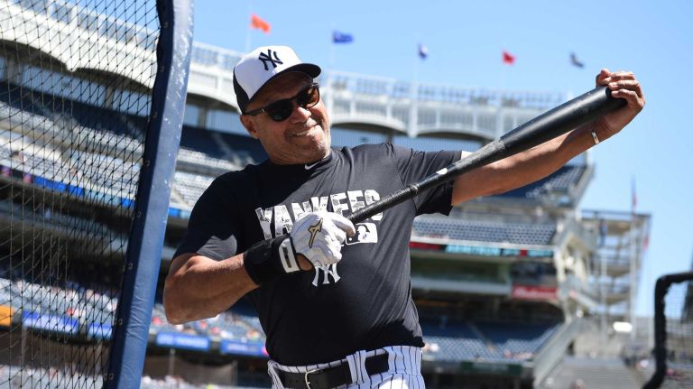Former New York Yankees player Reggie Jackson stretches during the 70th annual Old-Timers' Day at Yankee Stadium on Sunday, June 12, 2016.