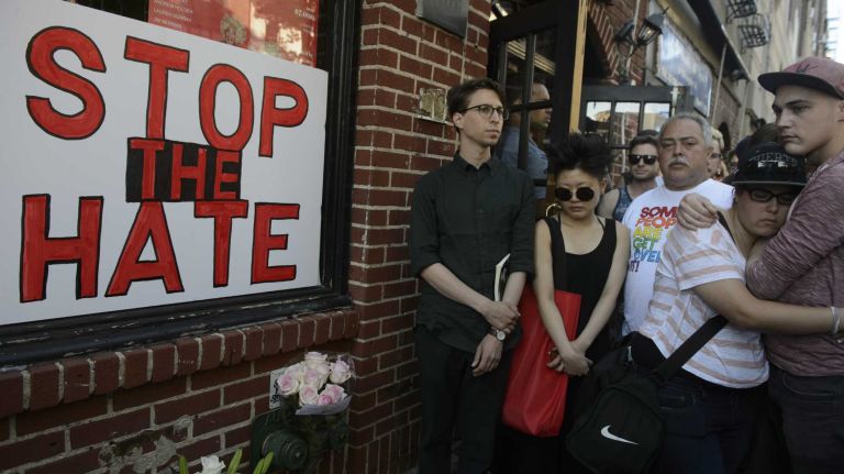 People gather at The Stonewall Inn in Manhattan on Sunday, June 12, 2016, at a vigil for Orlando, Fla., shooting victims. A gunman armed with an assault rifle and handgun killed 49 people and wounded 53 at Pulse, a gay nightclub in Orlando, in what officials termed the worst mass shooting in U.S. history.