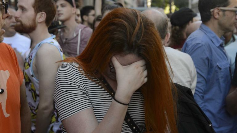 People gather at The Stonewall Inn in Manhattan on Sunday, June 12, 2016, at a vigil for Orlando, Fla., shooting victims. A gunman armed with an assault rifle and handgun killed 49 people and wounded 53 at Pulse, a gay nightclub in Orlando, in what officials termed the worst mass shooting in U.S. history.