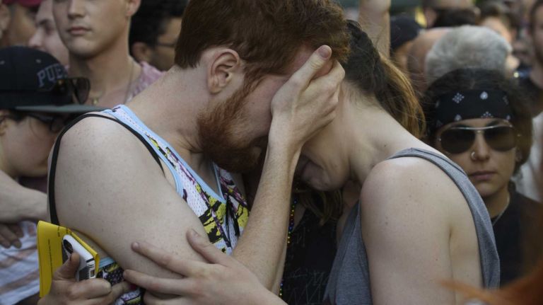Mourners embrace at The Stonewall Inn in Manhattan on Sunday, June 12, 2016, at a vigil for the victims of the mass shooting attack in Orlando, Fla. A gunman armed with an assault rifle and handgun killed 49 people and wounded 53 at Pulse, a gay nightclub in Orlando, in what officials termed the worst mass shooting in U.S. history.