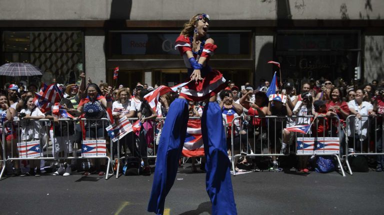 Puerto Rican Day Parade NYC 2016 43 A woman on stilts entertains the crowd as she marches in the 59th Annual Puerto Rican Day Parade in Manhattan on Sunday, June 12, 2016.