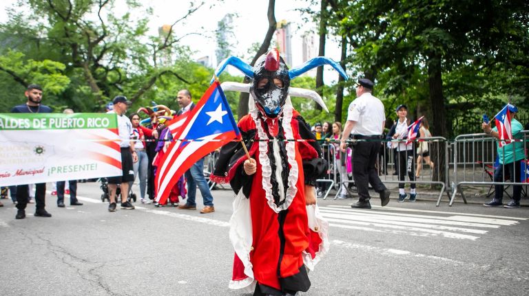 A young participant marches along Fifth Avenue at the 61st annual National Puerto Rican Day Parade.