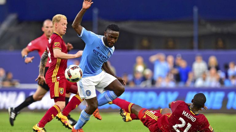 NYCFC vs. Real Salt Lake 34 New York City FC midfielder Andrea Pirlo (21) attempts to control the ball under pressure from Real Salt Lake midfielder Luke Mulholland (19) and defender Aaron Maund (21) in an MLS game at Yankee Stadium in Bronx, New York on Thursday, Jun 2, 2016.