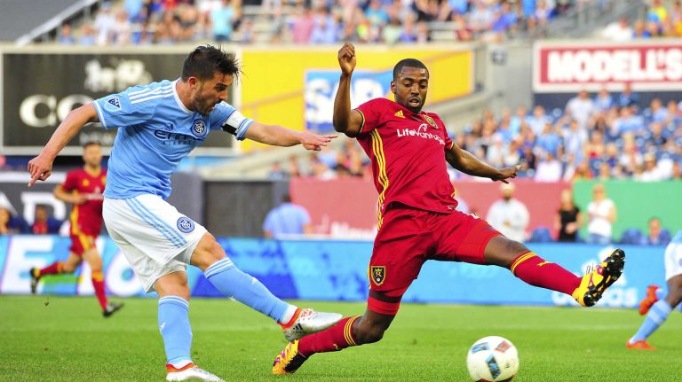 NYCFC vs. Real Salt Lake 41 New York City FC forward David Villa (7) attempts a shot on goal under pressure from Real Salt Lake defender Aaron Maund (21) in an MLS game at Yankee Stadium in Bronx, New York on Thursday, Jun 2, 2016.