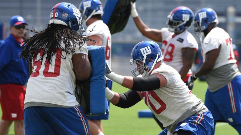 Giants offensive guard Adam Gettis and New York Giants center Weston Richburg and teammates participate in a drill during an OTA at Quest Diagnostics Training Center on Wednesday, June 1, 2016.