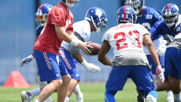 New York Giants quarterback Eli Manning and teammates runs a drill during the Giants Organized Team Activities at Quest Diagnostics Training Center on Wednesday, June 1, 2016.