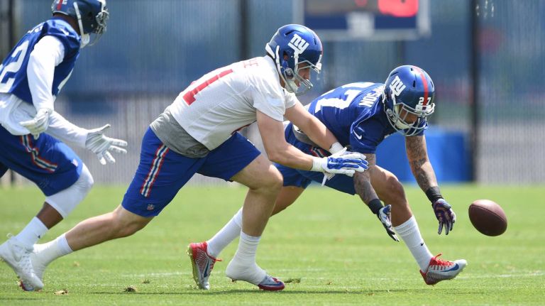 New York Giants safety Darian Thompson runs after the football against tight end Matt LaCosse during the Giants Organized Team Activities at Quest Diagnostics Training Center on Wednesday, June 1, 2016.