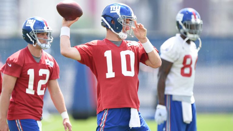 New York Giants quarterback Eli Manning passes the football during the Giants Organized Team Activities at Quest Diagnostics Training Center on Wednesday, June 1, 2016.