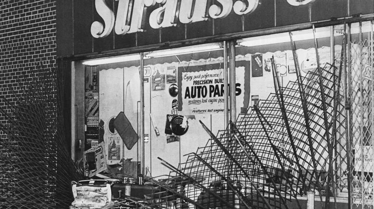 A Strauss Store on Liberty Avenue in Jamaica, Queens, had its metal curtain ripped down by looters during the blackout on July 14, 1977.