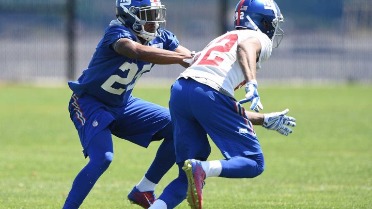 New York Giants cornerback Tramain Jacobs and wide receiver Roger Lewis run a play during the Giants Organized Team Activities at Quest Diagnostics Training Center on Monday, May 23, 2016.