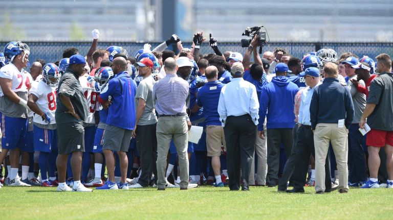 New York Giants players and coaches huddle after field practice during the Giants Organized Team Activities at Quest Diagnostics Training Center on Monday, May 23, 2016.