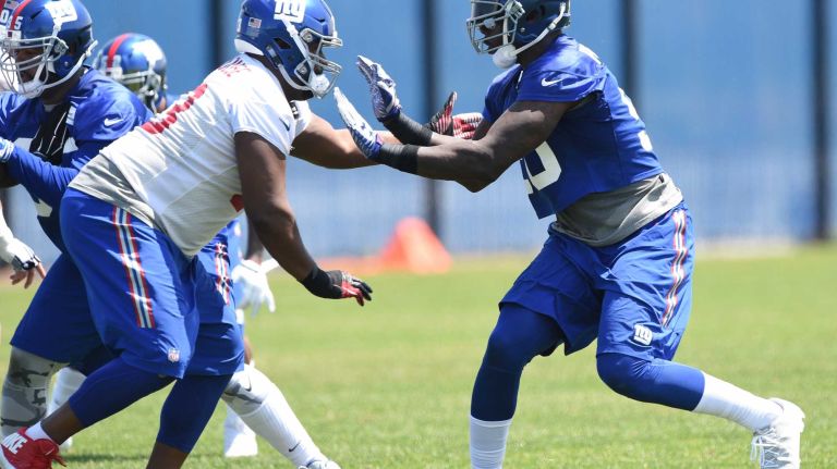 New York Giants offensive tackle Marshall Newhouse and Giants defensive end Jason Pierre-Paul run a play during the Giants Organized Team Activities at Quest Diagnostics Training Center on Monday, May 23, 2016.