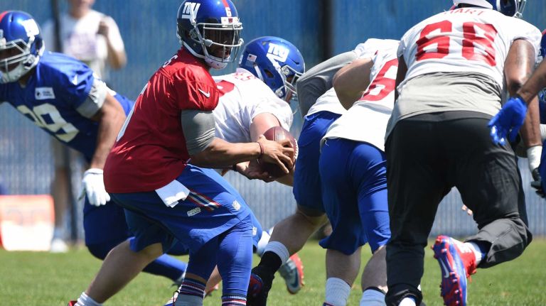 New York Giants quarterback B.J. Daniels looks for an open player during the Giants Organized Team Activities at Quest Diagnostics Training Center on Monday, May 23, 2016.