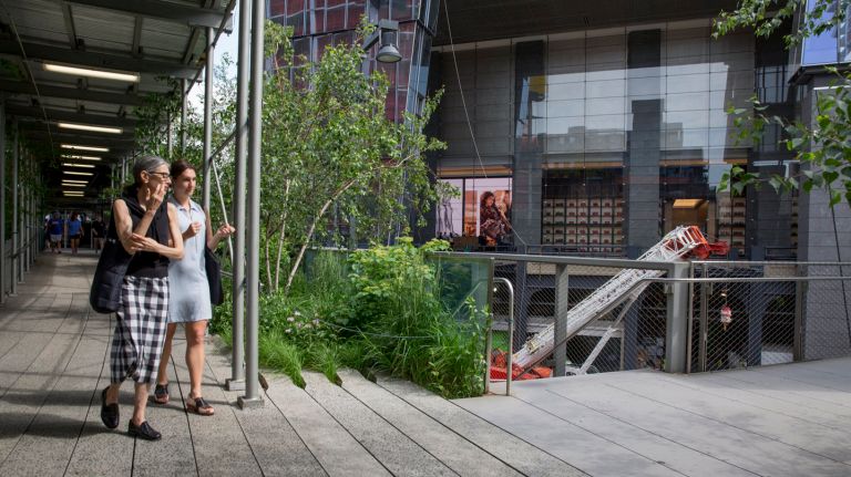 10 Hudson Yards welcomes first tenant: See pictures 12 People walk along the High Line with the newly opened 10 Hudson Yards in the background on May 31, 2016.