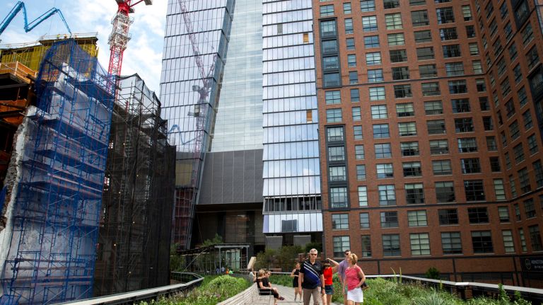 10 Hudson Yards welcomes first tenant: See pictures 16 People walk along the High Line, with 10 Hudson Yards building in the background, on May 31, 2016.