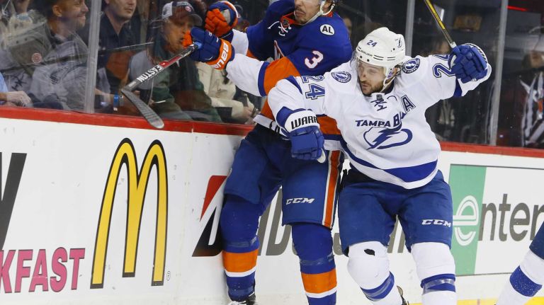 New York Islanders defenseman Travis Hamonic (3) and Tampa Bay Lightning right wing Ryan Callahan (24) battle along the boards in the third period in Game 3 of the Eastern Conference semifinals on Tuesday, May 3, 2016 at Barclays Center.