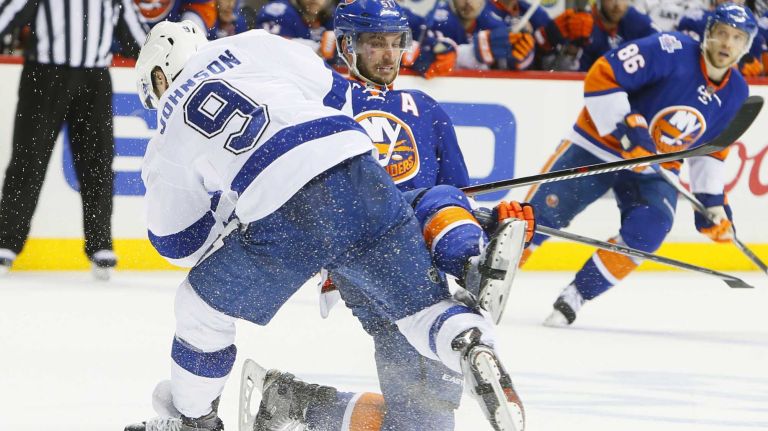 New York Islanders center Frans Nielsen (51) is checked by Tampa Bay Lightning center Tyler Johnson (9) in the third period in Game 3 of the Eastern Conference semifinals on Tuesday, May 3, 2016 at Barclays Center.