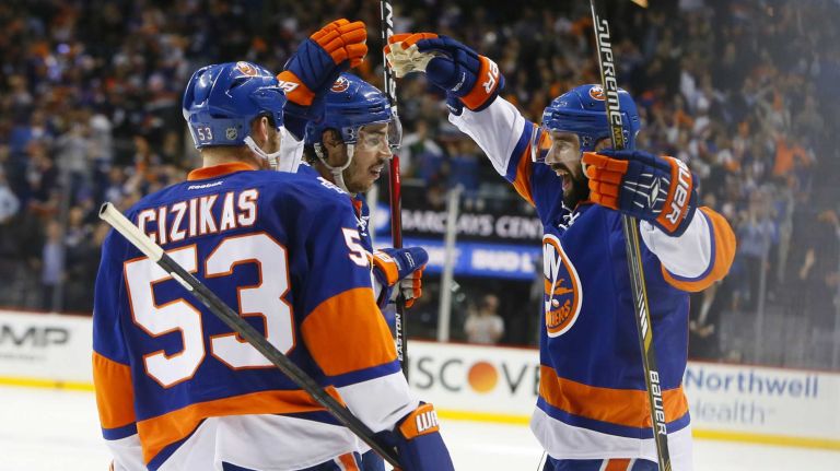 New York Islanders center Casey Cizikas (53), defenseman Travis Hamonic (3) and defenseman Nick Leddy (2) celebrate after Leddys' goal in the second period in Game 3 of the Eastern Conference semifinals against the Tampa Bay Lightning on Tuesday, May 3, 2016 at Barclays Center.