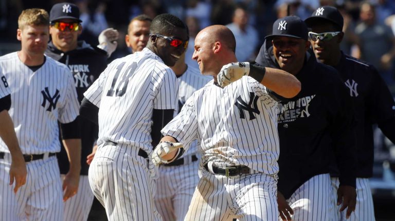Yankees vs. Rays 83 Brett Gardner #11 of the New York Yankees celebrates his ninth inning game winning home run against the Tampa Bay Rays with his teammates at Yankee Stadium on Saturday, April 23, 2016 in the Bronx Borough of New York City.