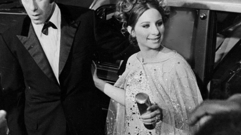 Barbra Streisand and husband Elliott Gould enter the Criterion Theater at Broadway and 43rd Street in Manhattan for the premiere of Streisand's film 