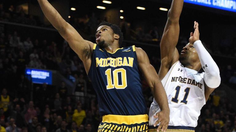 NCAA Tournament: Notre Dame vs. Michigan 15 Michigan Wolverines guard Derrick Walton Jr. puts up a layup past Notre Dame Fighting Irish guard Demetrius Jackson during the first round of an East Regional men's basketball game in the NCAA Tournament at Barclays Center on Friday, March 18, 2016.