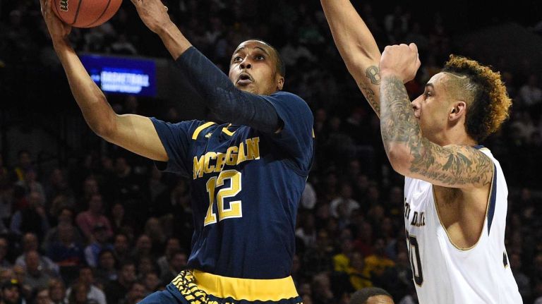 NCAA Tournament: Notre Dame vs. Michigan 17 Michigan Wolverines guard Muhammad-Ali Abdur-Rahkman puts up a shot past Notre Dame Fighting Irish forward Zach Auguste during the first round of an East Regional men's basketball game in the NCAA Tournament at Barclays Center on Friday, March 18, 2016.