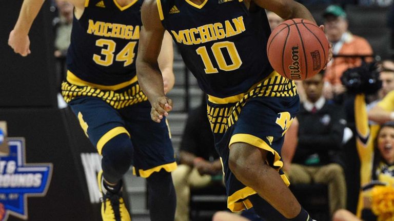 NCAA Tournament: Notre Dame vs. Michigan 22 Michigan Wolverines guard Derrick Walton Jr. drives the ball against the Notre Dame Fighting Irish during the first round of an East Regional men's basketball game in the NCAA Tournament at Barclays Center on Friday, March 18, 2016.