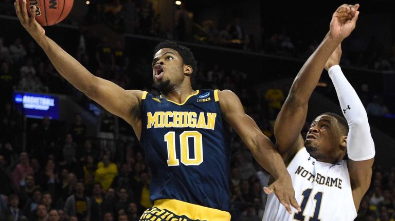 NCAA Tournament: Notre Dame vs. Michigan 24 Michigan Wolverines guard Derrick Walton Jr. puts up a layup past Notre Dame Fighting Irish guard Demetrius Jackson during the first round of an East Regional men's basketball game in the NCAA Tournament at Barclays Center on Friday, March 18, 2016.