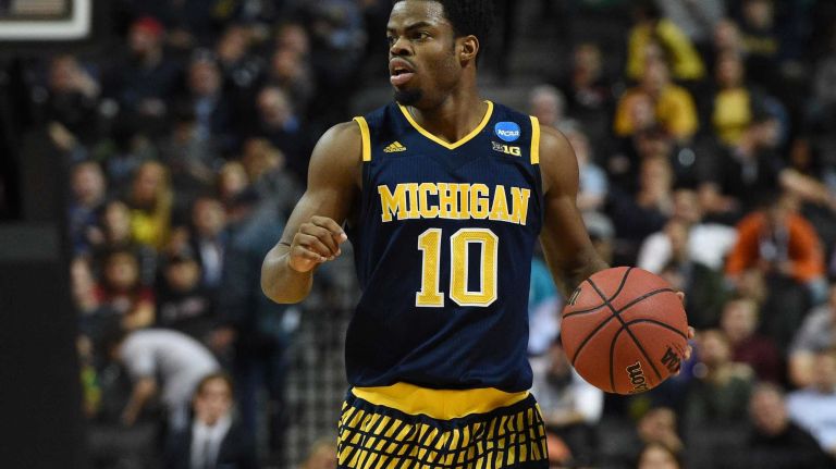 NCAA Tournament: Notre Dame vs. Michigan 25 Michigan Wolverines guard Derrick Walton Jr. looks to pass against the Notre Dame Fighting Irish during the first round of an East Regional men's basketball game in the NCAA Tournament at Barclays Center on Friday, March 18, 2016.