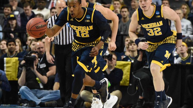 NCAA Tournament: Notre Dame vs. Michigan 27 Michigan Wolverines guard Muhammad-Ali Abdur-Rahkman dribbles the ball up court against the Notre Dame Fighting Irish during the first round of an East Regional men's basketball game in the NCAA Tournament at Barclays Center on Friday, March 18, 2016.