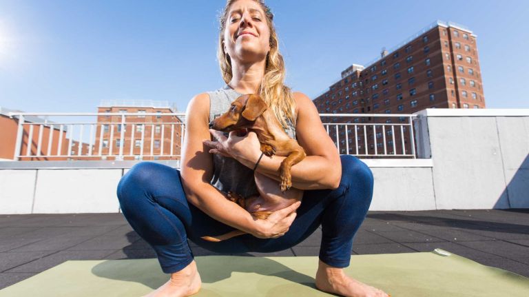 You can easily cradle your pup - or use him as a free weight - in this low squat.