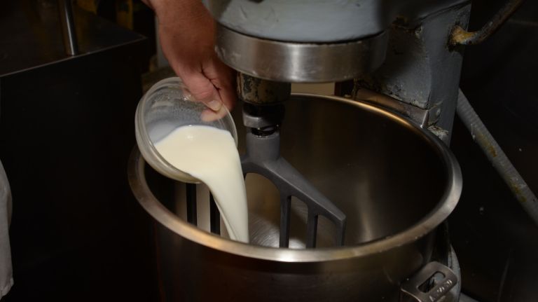 Add whole milk to the mixing bowl fitted with the paddle attachment to begin making the sweet dough. 