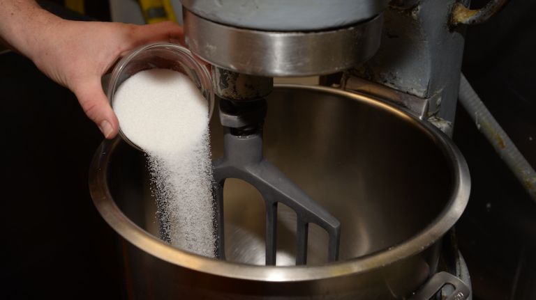 After you pour the milk, add sugar and salt to the mix. 