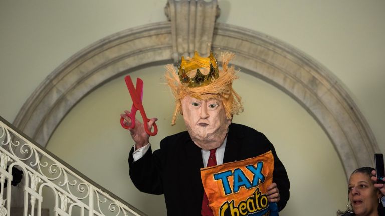 A  Trump mask at q rally  with  elected officials  at City Hall to speak out against the GOP's tax reform plan in NYC, on Nov. 12, 2017.
