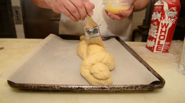 The egg glaze will give the bread a sheen and also a pleasantly light crust. It is also a bit sticky, which allows the nonpareils to stick to it. Add those now. 