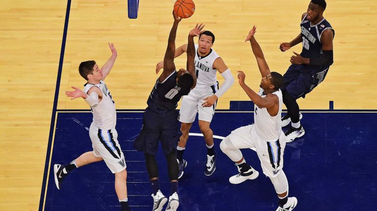 Georgetown guard L.J. Peak (0) attempts a lay up under pressure from the Villanova defense during the Big East Tournament at Madison Square Garden in New York, New York on Thursday, Mar 10, 2016. Big East Basketball Tournament between #8 Georgetown and #1 Villanova.