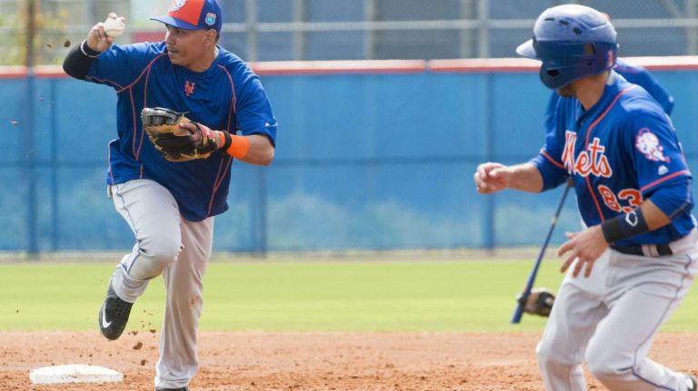 New York Mets infielder Ruben Tejada chases a baserunner on Monday, Feb. 29, 2016 during a spring training workout in Port St. Lucie, Fla.