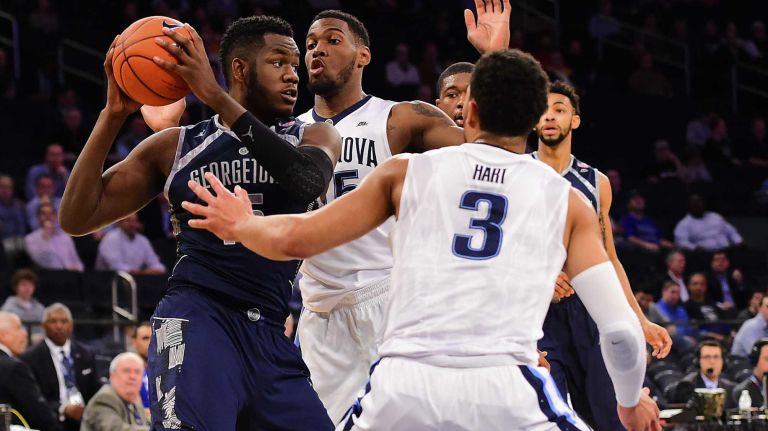 Georgetown center Jessie Govan (15) is defended by Villanova guard Mikal Bridges (25) and guard Josh Hart (3) during the Big East Tournament at Madison Square Garden on Thursday, March 10, 2016.