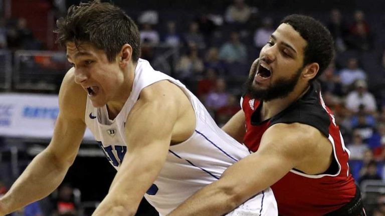 Grayson Allen #3 of the Duke Blue Devils dribbles past Caleb Martin #14 of the North Carolina State Wolfpack during the first half in the second round of the 2016 ACC Basketball Tournament at Verizon Center on March 9, 2016 in Washington, DC.