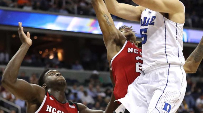 Luke Kennard #5 of the Duke Blue Devils shoots in front of Shaun Kirk #22 of the North Carolina State Wolfpack during the first half in the second round of the 2016 ACC Basketball Tournament at Verizon Center on March 9, 2016 in Washington, DC. 