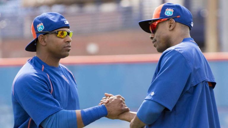 Mets outfielders Yoenis Cespedes, left, and Curtis Granderson greet one another during a spring training workout on Monday, Feb. 22, 2016 in Port St. Lucie, Fla.