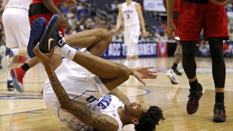 Brandon Ingram #14 of the Duke Blue Devils holds his foot against the North Carolina State Wolfpack during the first half in the second round of the 2016 ACC Basketball Tournament at Verizon Center on March 9, 2016 in Washington, DC. 