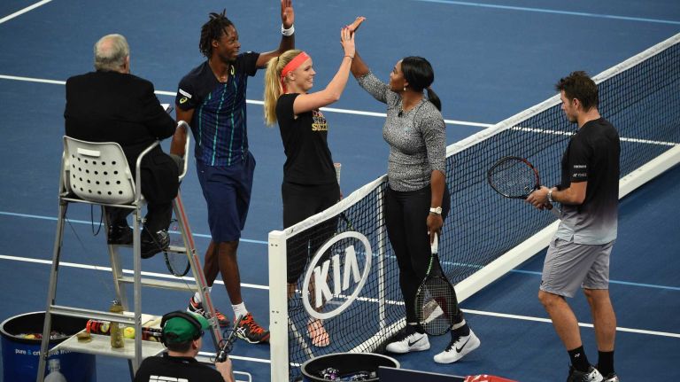 Gael Monfils and Caroline Wozniacki high five with Serena Williams and Stan Wawrinka after playing a game of doubles during the 9th annual BNP Paribas Showdown at Madison Square Garden on Tuesday, March 8, 2016.