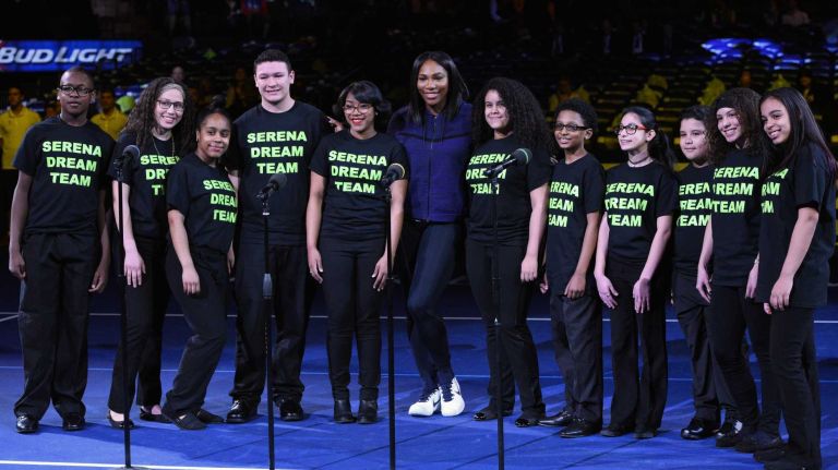 Serena Williams looks on with members of a children's choir from center court during the 9th annual BNP Paribas Showdown at Madison Square Garden on Tuesday, March 8, 2016.