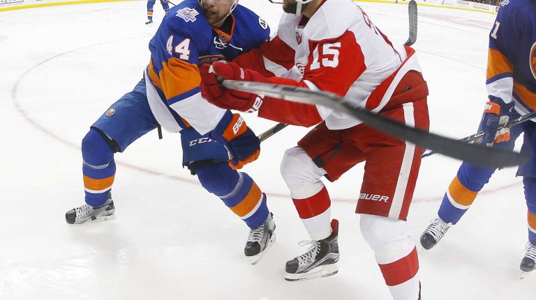 Calvin de Haan #44 of the New York Islanders defends against Riley Sheahan #15 of the Detroit Red Wings in the second period at Barclays Center on Monday, Feb. 15, 2016 in Brooklyn, New York.